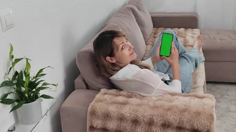 Handheld Camera: Back View of Woman at Kitchen Room Using Phone With Green Mock Stock Footage 276916315