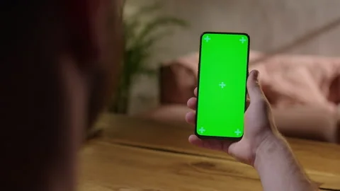 Handheld Camera: Back View of Young Man at Home Sitting on a Wood Desk using Stock Footage 164921431