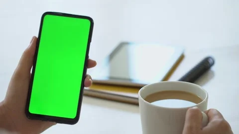 Handheld Camera: business woman using smartphone viewing green screen on mobile Video stock 140525992