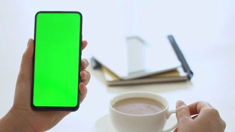 Handheld Camera: business woman using smartphone viewing green screen on mobile Stock Footage 141356268