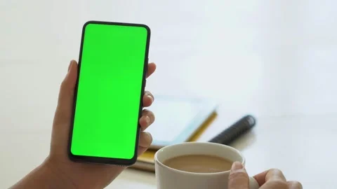 Handheld Camera: business woman using smartphone viewing green screen on mobile Stock Footage 141379433
