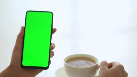 Handheld Camera: business woman using smartphone viewing green screen on mobile Stock Footage 142490284
