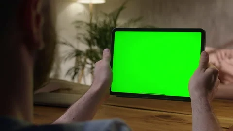 Handheld Camera: Over The Shoulder View Young Man at Home Using With Green Mock Stock Footage 164920353