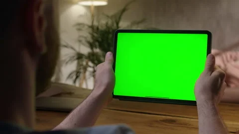 Handheld Camera: Over The Shoulder View Man Using Hand Gestures on Green Mock-up Stock Footage 164920782