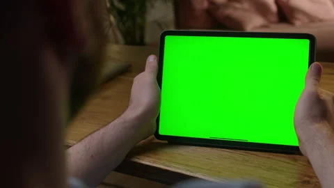 Handheld Camera: Over The Shoulder View Man Using Hand Gestures on Green Mock-up Stock Footage 164921131