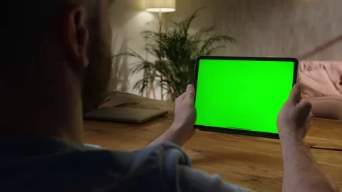 Handheld Camera: Over The Shoulder View Young Man at Home Using With Green Mock Stock Footage 165292359