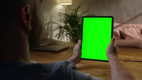 Handheld Camera: Over The Shoulder View Young Man at Home Using With Green Mock Stock Footage 165294557