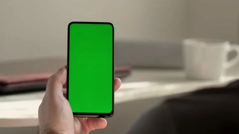 Handheld Camera: Point of View of business man using smartphone viewing green Stock Footage 154483451