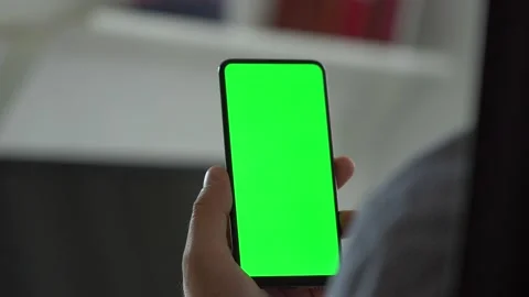 Handheld Camera: Point of View of Man at Room Sitting on a Chair Using Phone Stock Footage 138473201
