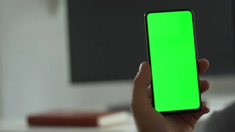 Handheld Camera: Point of View of Man at Room Sitting on a Chair Using Phone Video stock 138779971