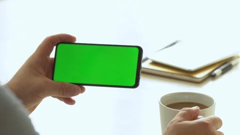 Handheld Camera: Point of View of Man at Room Sitting on a Chair Using Phone Stock Footage 141129911