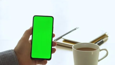 Handheld Camera: Point of View of Man at Room Sitting on a Chair Using Phone Stock Footage 142066072
