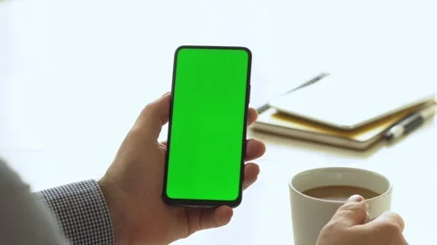 Handheld Camera: Point of View of Man at Room Sitting on a Chair Using Phone Stock Footage 143608950