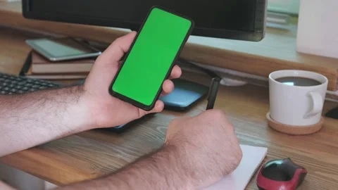 Handheld Camera: Point of View of Man at Room Sitting on a Chair Using Phone Stock-Footage 200451043