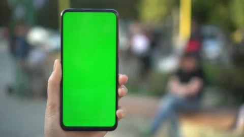 Handheld Camera: Point of View of woan at street Using Phone With Green Mock-up Stock Footage 138132824