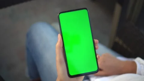 Handheld Camera: Point of View of woan at street Using Phone With Green Mock-up Stock Footage 138475003