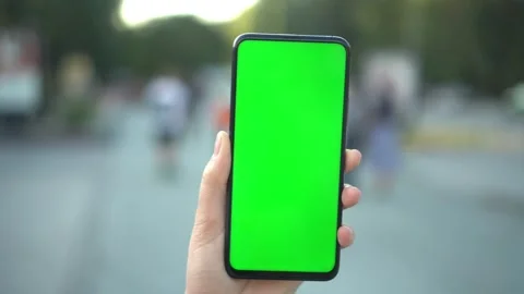 Handheld Camera: Point of View of woan at street Using Phone With Green Mock-up Stock Footage 138590994