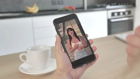 Handheld Camera: Point of View of woman at Modern Room Sitting on a Chair Using  Stock Footage 134843884