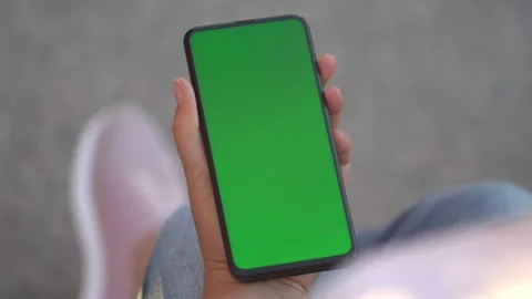 Handheld Camera: Point of View of Woman at street Using Phone With Green Mock-up Stock Footage 136717786