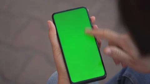 Handheld Camera: Point of View of Woman at street Using Phone With Green Mock-up Stock Footage 136798182