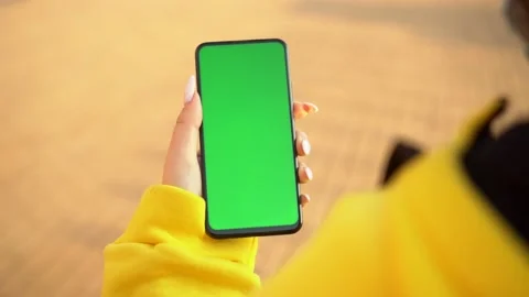 Handheld Camera: Point of View of Woman at street Using Phone With Green Mock-up Video stock 141890565
