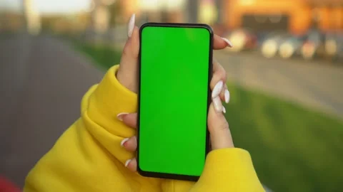 Handheld Camera: Point of View of Woman at street Using Phone With Green Mock-up Stock Footage 142004465