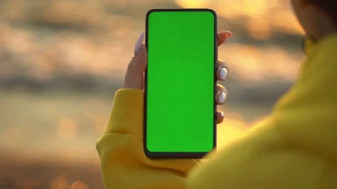 Handheld Camera: Point of View of Woman at beach Using Phone With Green Mock-up 스톡 동영상 143441465