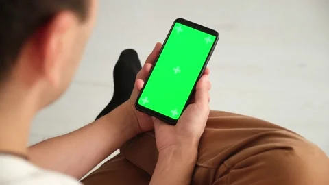 Handheld Camera: Point of View of Woman at Phone with Green Screen for Copy Stock Footage 143528008