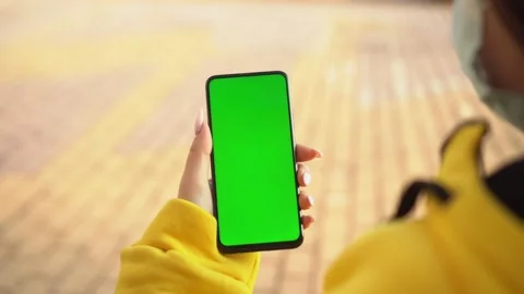 Handheld Camera: Point of View of Woman at street Using Phone With Green Mock-up Stock Footage 143607454