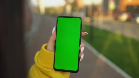 Handheld Camera: Point of View of Woman at street Using Phone With Green Mock-up Stock Footage 143608213