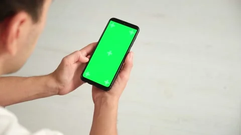 Handheld Camera: Point of View of Woman at Phone with Green Screen for Copy Stock Footage 144801880