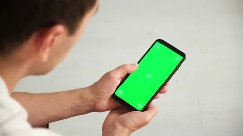 Handheld Camera: Point of View of Woman at Phone with Green Screen for Copy Stock Footage 147245600