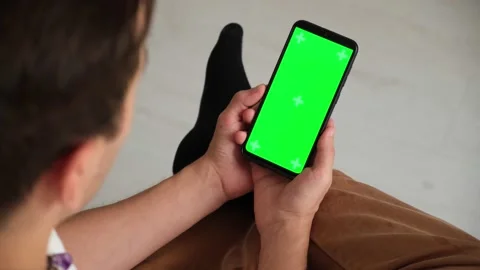 Handheld Camera: Point of View of Woman at Phone with Green Screen for Copy Stock Footage 147385510