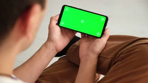 Handheld Camera: Point of View of Woman at Phone with Green Screen for Copy Stock Footage 149406149