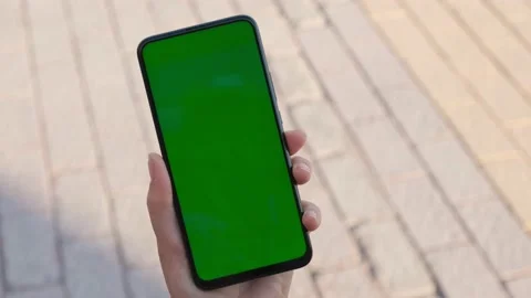 Handheld Camera: Point of View of Woman at street Using Phone With Green Mock-up Stock Footage 155180328