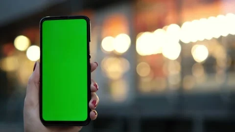 Handheld Camera: Point of View of Woman at street Using Phone With Green Mock-up Stock Footage 170132823