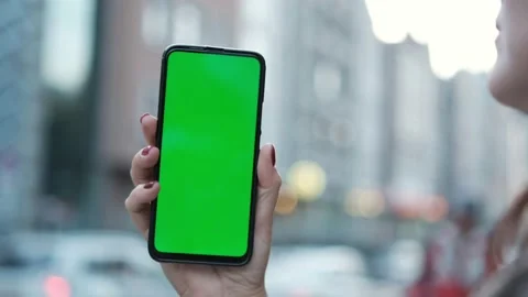 Handheld Camera: Point of View of Woman at street Using Phone With Green Mock-up Stock Footage 170355248