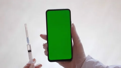 Handheld Camera: Point of View of Woman at Phone with Green Screen for Copy Stock Footage 182241280