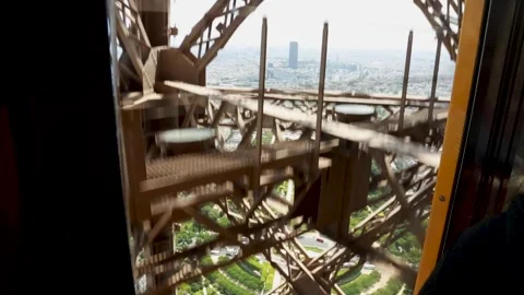Handheld camera shot inside the Eiffel Tower elevator ascending with the 스톡 동영상 241392978