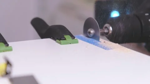 Handheld circular saw cutting white wood board Stock Footage 323560416