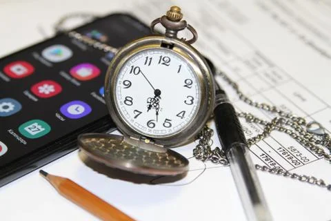 Handheld clock in office Stock Photos