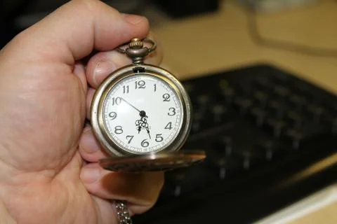 Handheld clock in office Stock Photos