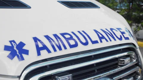 Handheld Close-Up of Ambulance Front with Emergency Medical Symbol - (4K UHD) 動画素材 344222459