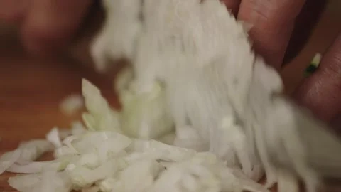 Handheld Close-Up of Chef Dicing Onion on Wooden Cutting Board Stock-Footage 321423665