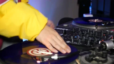 Handheld close up DJ scratching on vinyl at a dance event Stock Footage 155483591