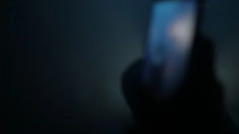 Handheld close-up of guy watches a video of a girl on his phone Vídeo Stock 114848433