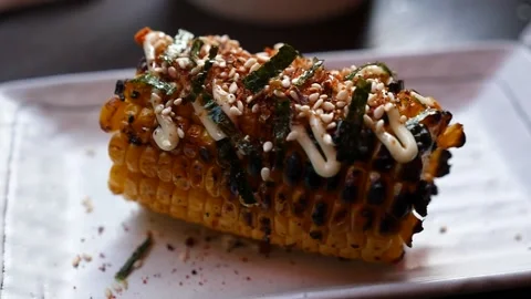 Handheld close up of japanese grilled corn Stock Footage 155776008