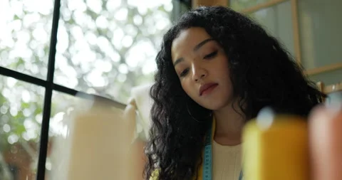 Handheld close up shot, Asian young female designer choose one of thread  Stockbeeldmateriaal 226303553