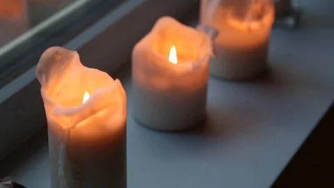 Handheld close-up shot of burning candles on the window Video stock 114846806
