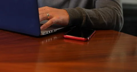 Handheld close-up shot of focused young man working on laptop at home Stock Footage 119936850